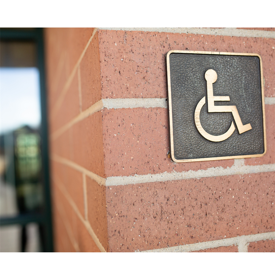 Photo of a disability icon on a plaque on a building