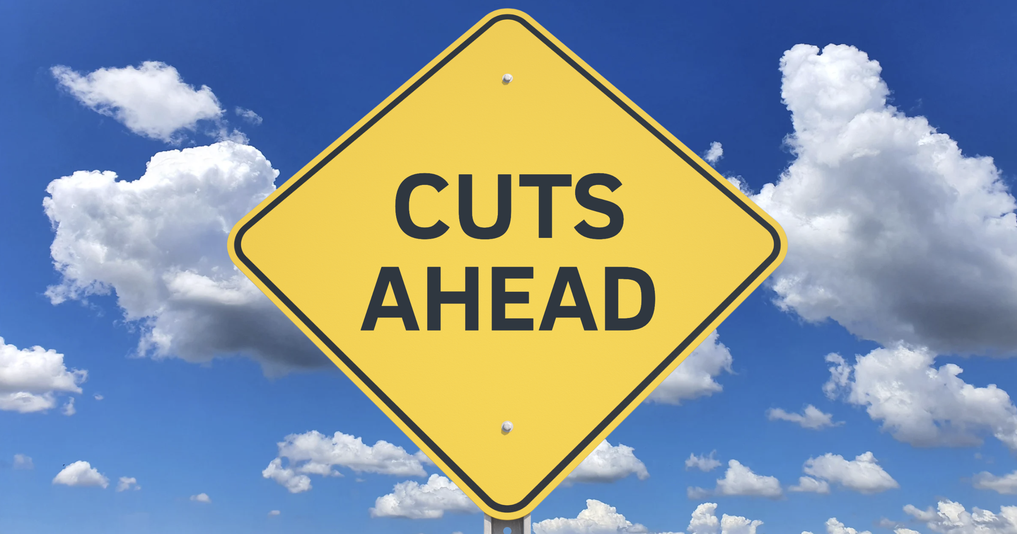 Road sign with the words "Cuts ahead" with a blue sky and clouds in the background