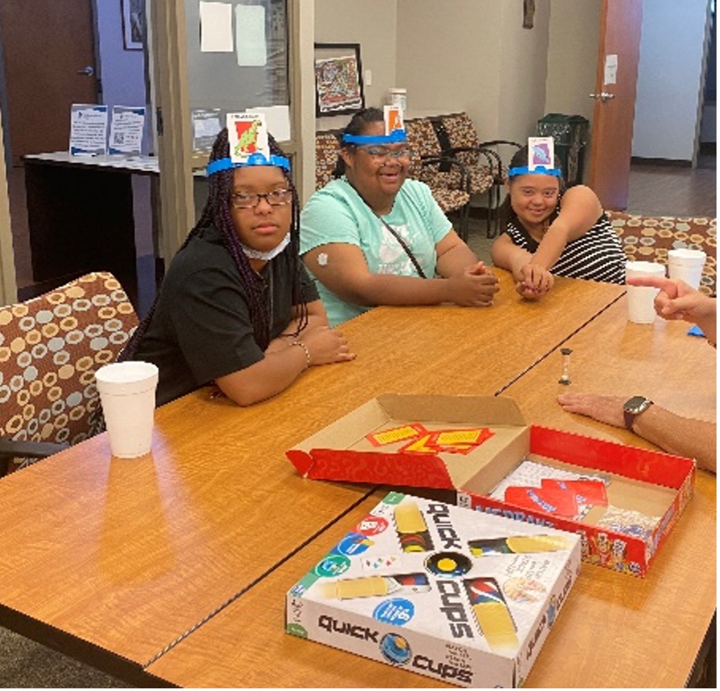 Board game night participants smile while playing games